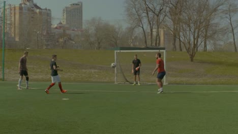 Young-soccer-players-practicing-football-on-field