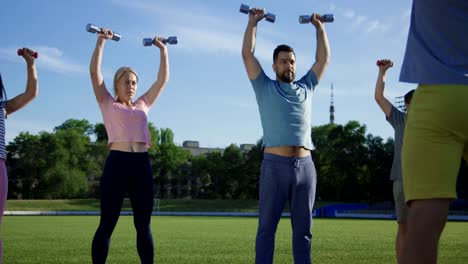 Family-training-with-personal-coach-on-field