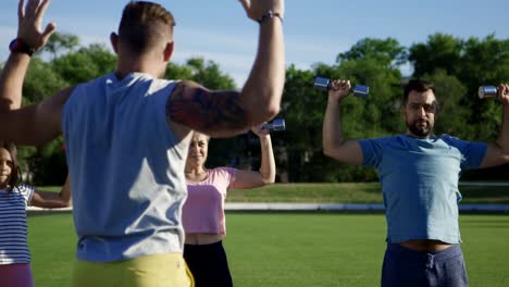 Family-training-with-personal-coach-on-field