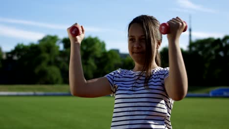 Children-training-with-dumbbells-outside