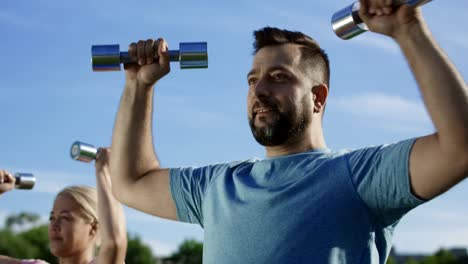 Man-training-family-with-kids-on-field