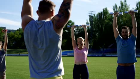 Family-training-with-personal-coach-on-field