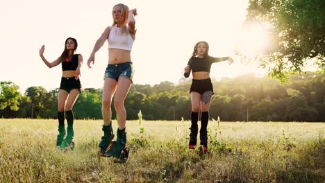 Three-girls-in-boots-on-springs-perform-fat-burning-exercises-in-group-training