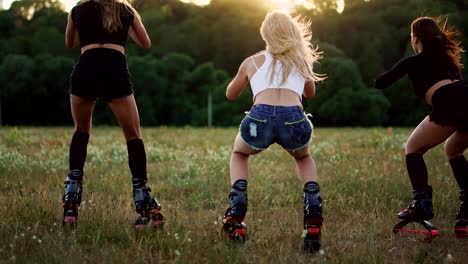 Group-training-kangoo.-Three-girls-at-sunset-perform-dynamic-squats-aimed-at-slimming-and-strengthening-the-muscles-of-the-thighs