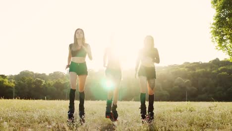 Three-girls-in-boots-with-springs-running-through-the-summer-Park-at-sunset-doing-sports