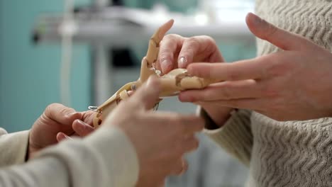 Close-up-of-two-engineers-discussing-artificial-hand-limb