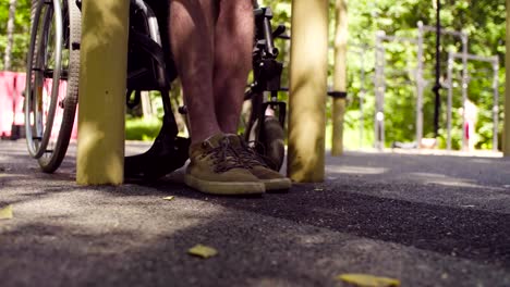 Legs-of-disable-man-sitting-down-in-a-wheelchair