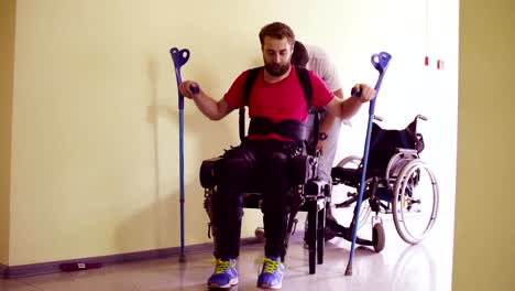 Young-disable-man-in-the-robotic-exoskeleton