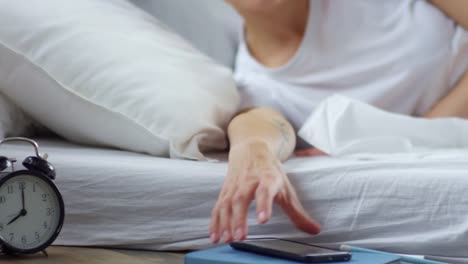 Woman-Waking-Up-and-Checking-Social-Media