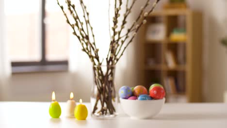 easter-eggs,-willow-and-candles-burning-at-home