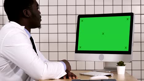 African-doctor-making-video-call-with-his-computer.-White-Display