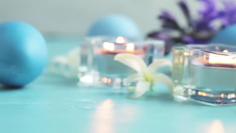 Blue-easter-eggs,-candles-and-white-hyacinth-on-blue-concrete-table-surface-background,-copy-space-for-you-text.-Festive-background.-Happy-Easter-greeting-card.