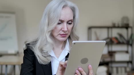 Old-Business-Woman-Using-Tablet