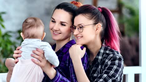 Friendly-happy-female-parent-enjoying-having-good-time-with-family-medium-close-up