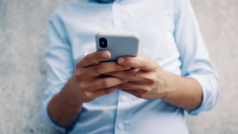 Close-up-of-man-texting-on-smartphone