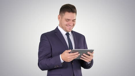 Businessman-Reading-or-Working-on-a-digital-tablet-on-gradient-background