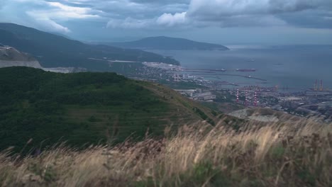 Footage-of-the-city-with-a-bay,-port,-buildings,-mountains.-Ariel-view-of-Novorossiysk.-Russia.