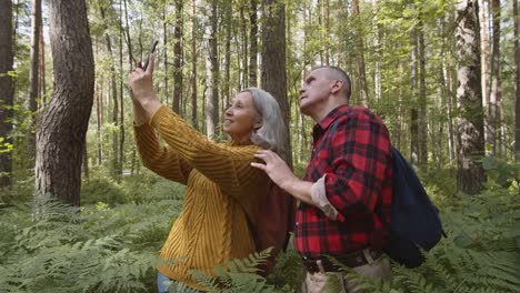 Aged-Family-Couple-Making-Photos-Outdoors