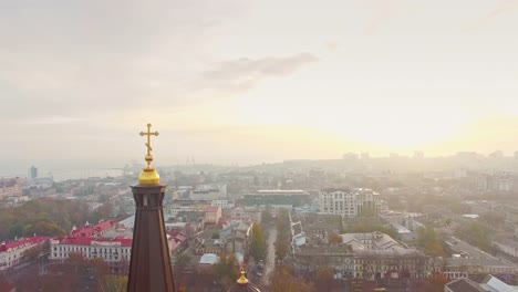 Aerial-view-of-Orthodox-Cross-over-the-old-city-center-of-Odessa-on-hazy-misty-early-morning.-Religion-concept.