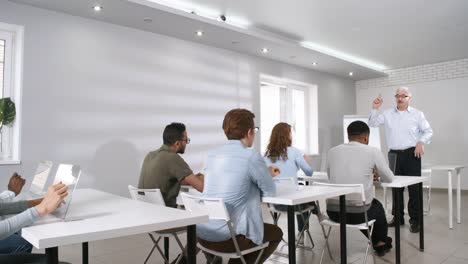 Elderly-Professor-Giving-Lecture-to-Students-with-Futuristic-Tablets