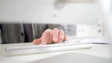 Close-up-of-man's-hands-using-desktop-computer