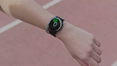 Runner-starting-smart-watch-timer-and-running.-Smart-watch-on-female-wrist.