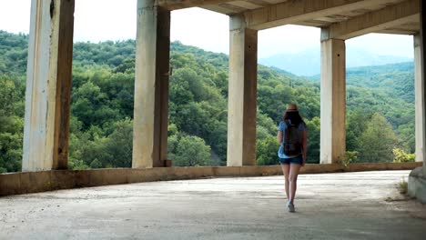 Young-female-traveler-with-backpack-walking-in-ancient-city