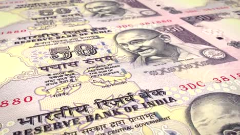 Banknotes-of-fifty-indian-rupees-of-India-rolling,-cash-money,-loop