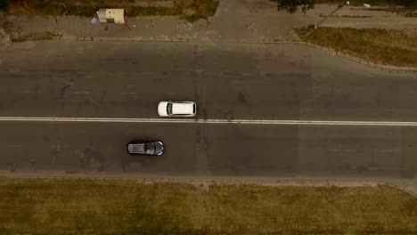 Aerial-shot-of-city-road-with-a-cars-and-electricity-line.