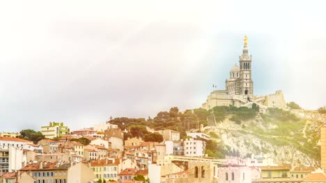 Ancient-church-with-golden-statue-on-roof,-nice-town-at-hill-bottom,-timelapse