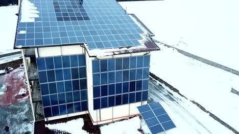 Hotel-complex-in-the-mountains-with-solar-panels-on-the-snow.