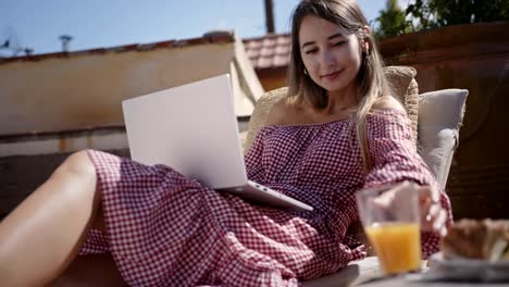 Young-blogger-working-on-laptop-and-relaxing-at-home