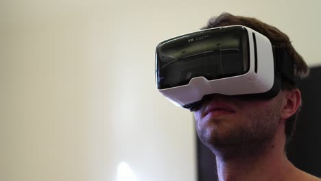 man-wearing-virtual-reality-headset-using-gestures-to-create-in-360-VR