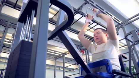 Bottom-view-of-weights-being-lifted-by-an-invalid-in-a-wheelchair