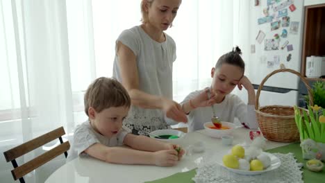 Happy-easter!-mother-and-children-having-fun-paint-and-decorate-eggs-for-holiday