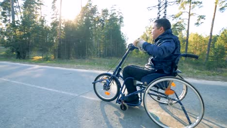 Behinderte-Person-fährt-Rollstuhl-Fahrrad,-Seitenansicht.