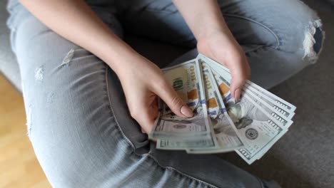 Closeup-of-woman-hands-counting-new-100-US-dollar-banknotes