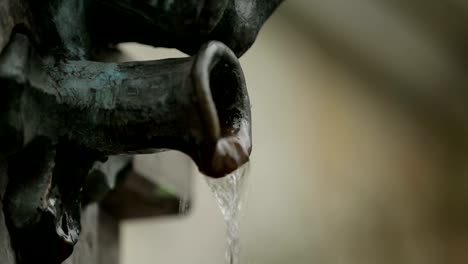 Cupid-boy-fountain-pouring-water,-old-town-architecture-in-Batumi,-love-symbol