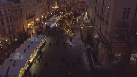 Lviv,-Ukraine---25,-December-2018.-Arial-shot.-Winter.-Rynok-square-street.-Christmas-Fair.-Lvov-Town-Hall,-City-Council.-People-are-walking-in-the-city-center.-Christmas-decorations-and-lights.-Night-time