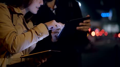 Couple-using-tablet-pc-together-in-night-city