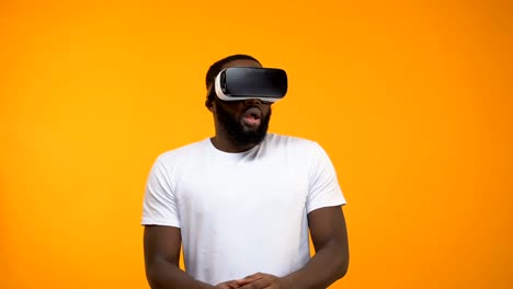 Scared-African-American-man-using-virtual-reality-headset,-simulation,-close-up