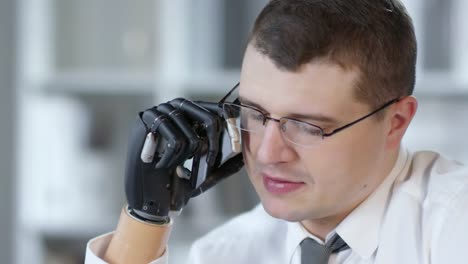 Disabled-Businessman-with-Prosthetic-Arm-Talking-on-Phone