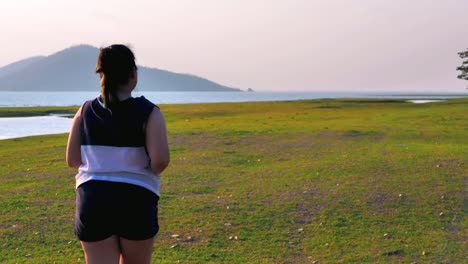 An-Asian-woman-jogging-in-natural-sunlight-in-the-evening.
She-is-trying-to-lose-weight-with-exercise.--concept-health-with-exercise.-Slow-Motion