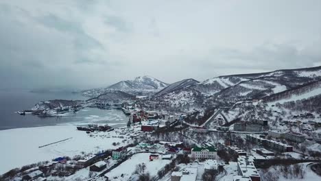 Aerial-view-of-Kamchatka-biggest-city-of-Petropavlosk,-volcanos-and-city