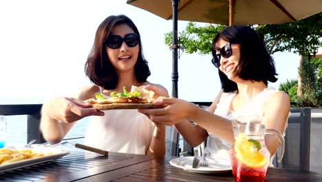 Two-beautiful-mature-women-having-dinner-at-restaurant-together.-Women-enjoying-with-her-special-dinner.-People-with-travel,-holidays,-celebration-concept.