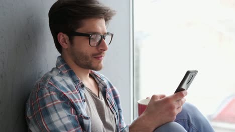 Young-man-text-messaging-on-mobile-phone