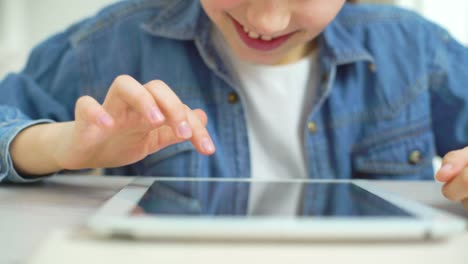 closeup-of-little-girl-fingers-touching-screen-of-tablet-while-playing-games