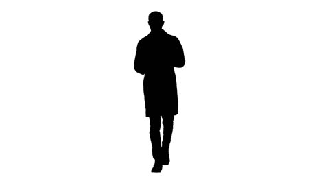 Silhouette-Mature-male-doctor-holding-digital-tablet-using-it-and-walking