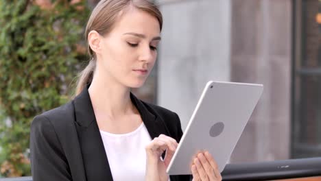 Young-Businesswoman-Sitting-Outdoor-and-Using-Tablet