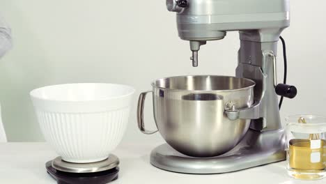 Mixing-royal-icing-in-electric-kitchen-mixer-for-Easter-cookies.